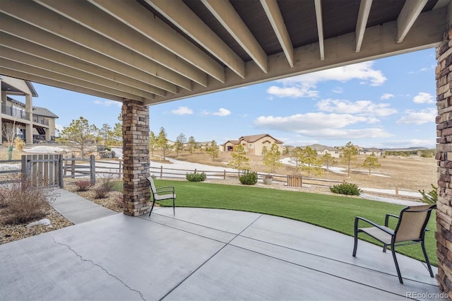 view of patio / terrace featuring a residential view and fence