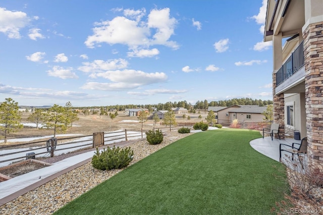 view of yard featuring a patio and fence