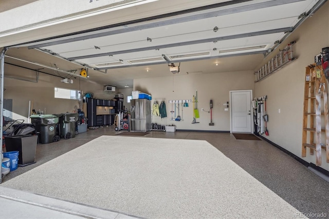 garage with a garage door opener and baseboards