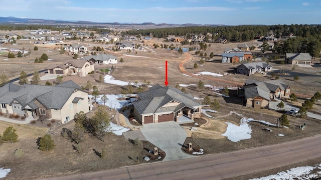 drone / aerial view featuring a residential view and a mountain view