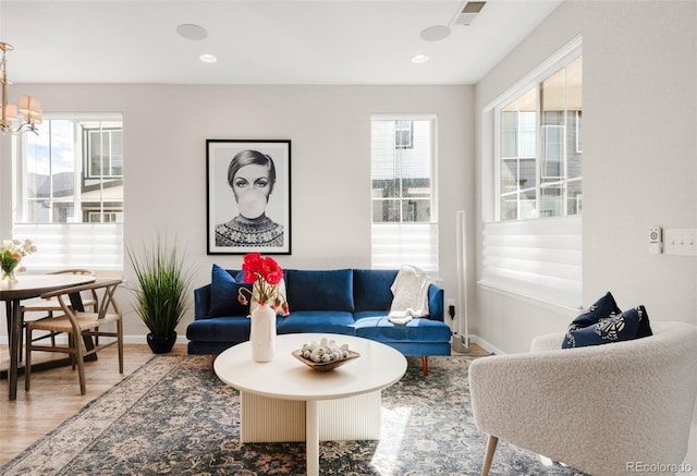 living room featuring recessed lighting, visible vents, a notable chandelier, and wood finished floors