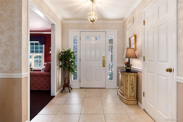 foyer featuring light tile patterned floors, ornamental molding, and wallpapered walls