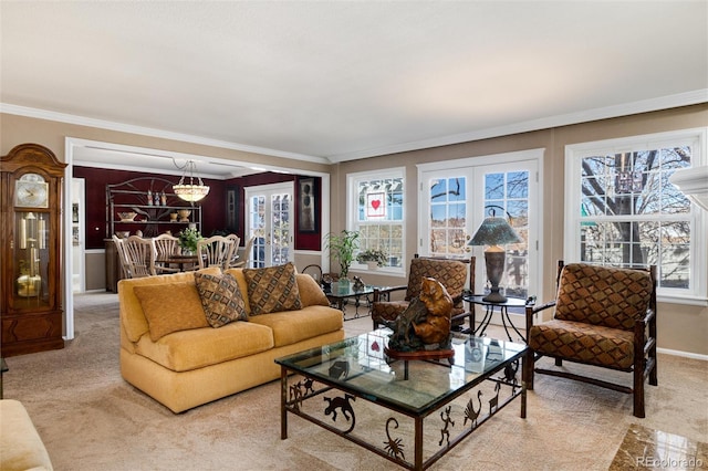 living room featuring carpet floors, ornamental molding, a chandelier, and french doors