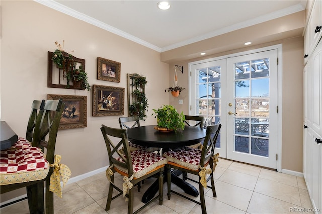 dining room featuring french doors, crown molding, baseboards, and light tile patterned floors