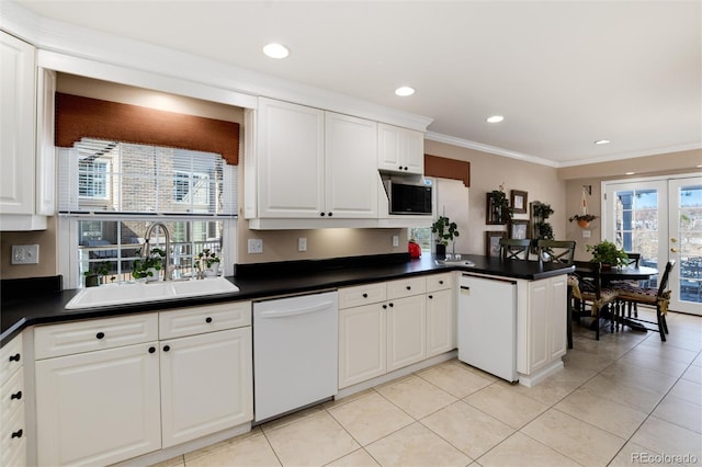 kitchen featuring a sink, dark countertops, dishwasher, and french doors