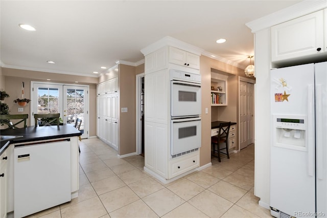 kitchen with light tile patterned floors, dark countertops, ornamental molding, white cabinetry, and white appliances