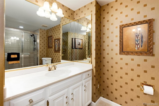 bathroom with visible vents, toilet, and wallpapered walls