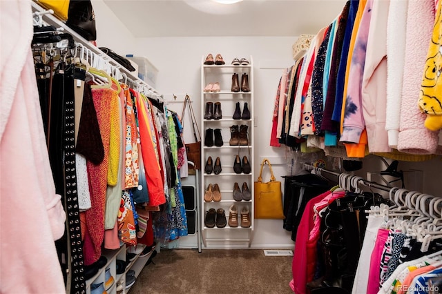 spacious closet with carpet flooring and visible vents