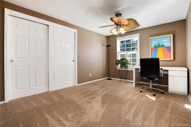 carpeted home office featuring ceiling fan and baseboards