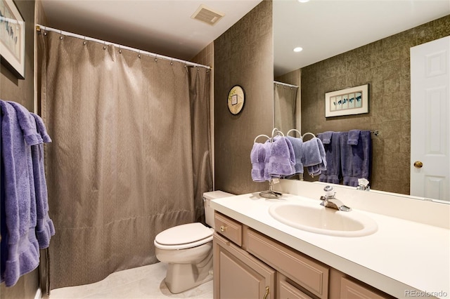 full bath with visible vents, toilet, tile patterned floors, vanity, and tile walls