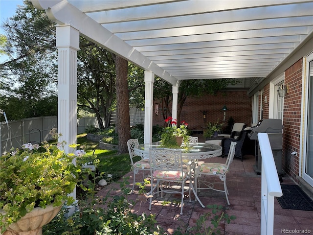 view of patio featuring a grill, fence, outdoor dining area, and a pergola