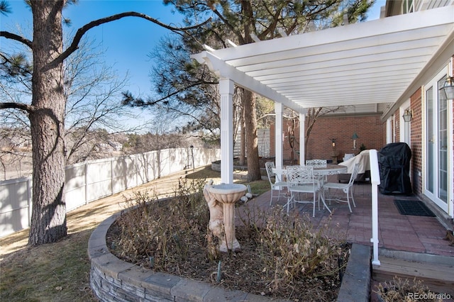 view of yard featuring outdoor dining space, a patio area, fence, and a pergola