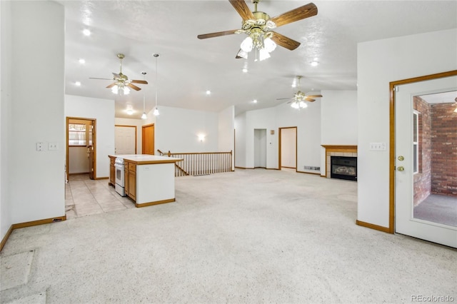 7216 W 18th St, Greeley, CO 80634 - unfurnished living room with light carpet, lofted ceiling, baseboards, and a ceiling fan