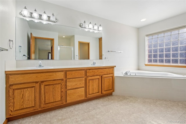 7216 W 18th St, Greeley, CO 80634 - bathroom with a sink, tile patterned floors, a stall shower, double vanity, and a garden tub