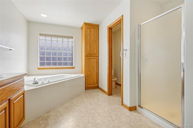 7216 W 18th St, Greeley, CO 80634 - full bathroom with toilet, vanity, a stall shower, baseboards, and a bath