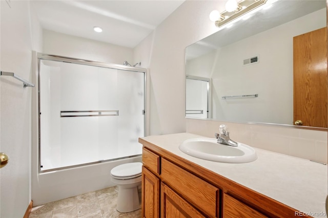 7216 W 18th St, Greeley, CO 80634 - full bath with toilet, visible vents, bath / shower combo with glass door, and vanity