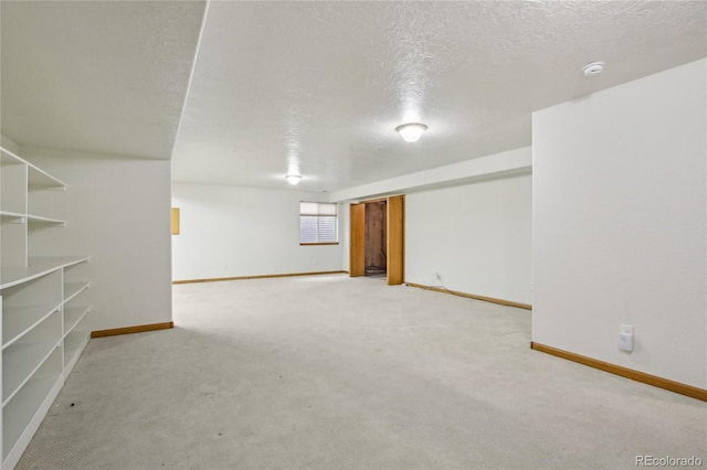 7216 W 18th St, Greeley, CO 80634 - basement with a textured ceiling, light carpet, and baseboards