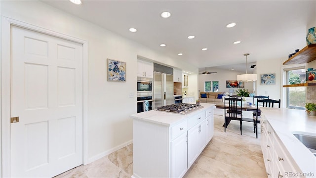 10886 Pheasant Run, Littleton, CO 80125 - kitchen featuring built in appliances, white cabinetry, recessed lighting, pendant lighting, and a center island