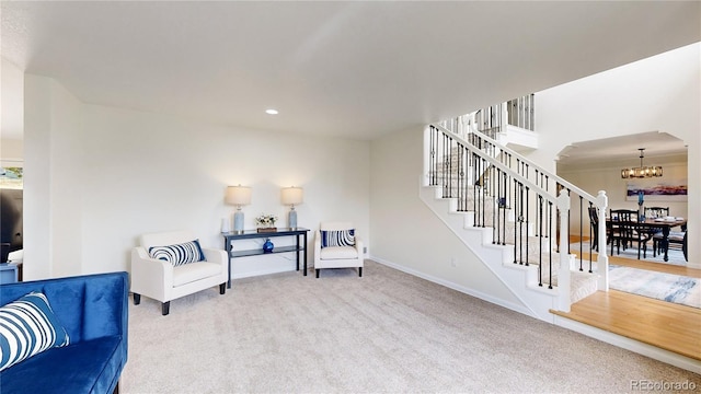 10886 Pheasant Run, Littleton, CO 80125 - living area with a chandelier, carpet floors, baseboards, stairway, and recessed lighting
