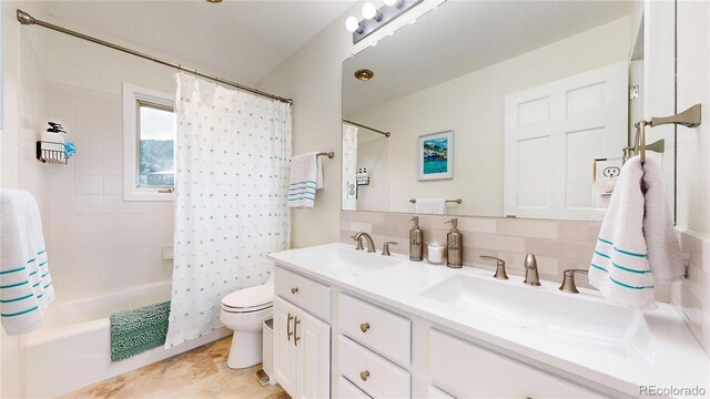10886 Pheasant Run, Littleton, CO 80125 - full bathroom featuring double vanity, shower / bath combo, toilet, and decorative backsplash