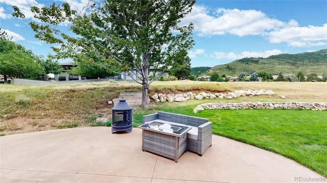 10886 Pheasant Run, Littleton, CO 80125 - view of patio featuring a mountain view and a fire pit