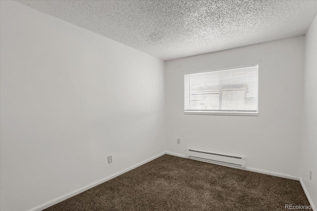 carpeted spare room featuring baseboard heating and a textured ceiling