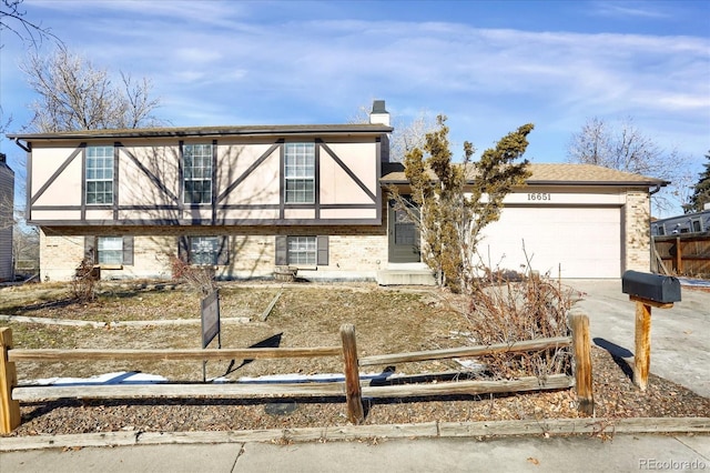 16651 E Arizona Pl, Aurora, CO 80017 - view of front of house with concrete driveway, a garage, brick siding, and a chimney