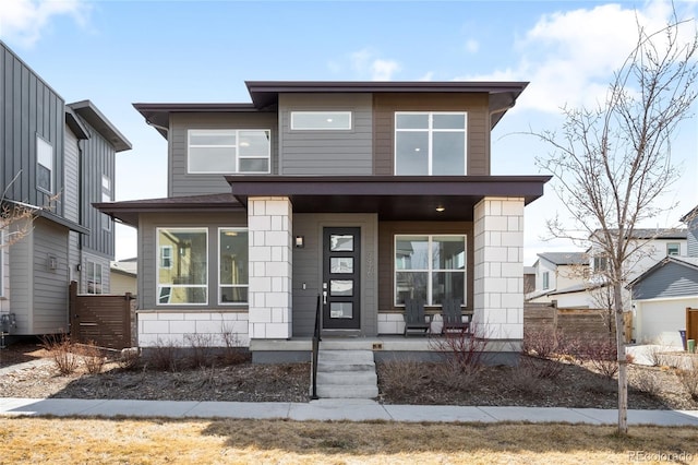 view of front of house featuring a porch and fence