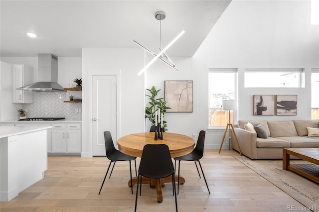 dining room with recessed lighting and light wood-type flooring