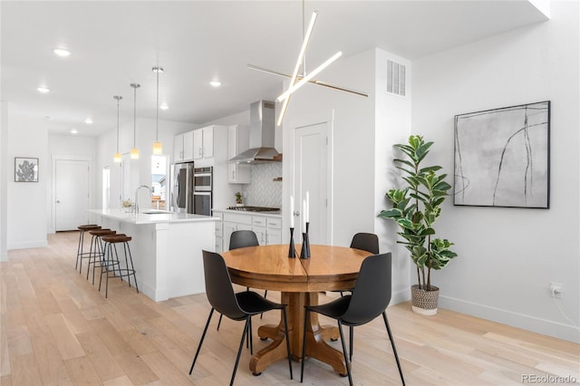 dining area with recessed lighting, visible vents, baseboards, and light wood-style flooring