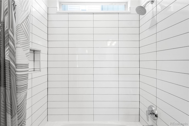 full bathroom with a wealth of natural light and tiled shower / bath combo