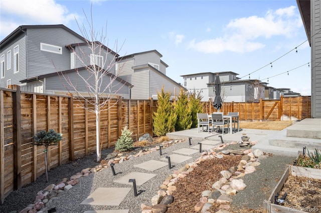 view of yard with a patio, a vegetable garden, and a fenced backyard