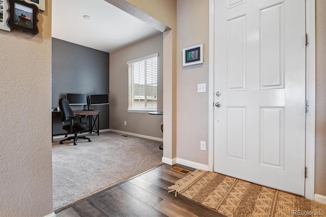 foyer featuring carpet floors