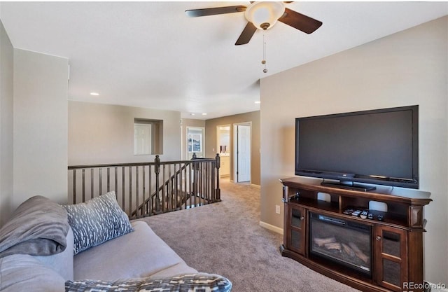 living room featuring ceiling fan and carpet