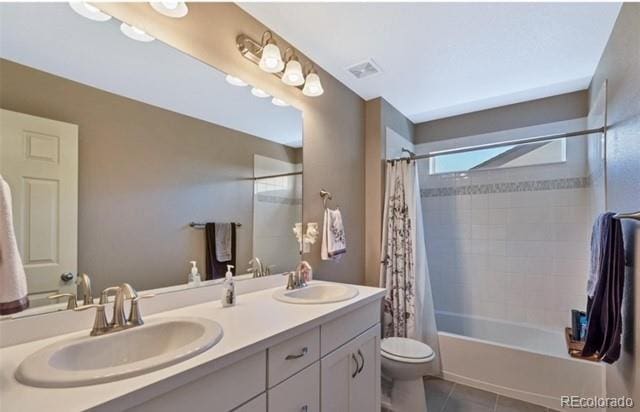 full bathroom featuring vanity, toilet, tile patterned floors, and shower / bath combo