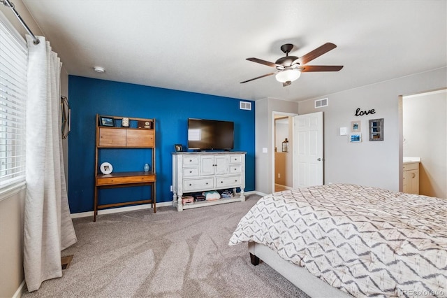 carpeted bedroom featuring ensuite bathroom and ceiling fan