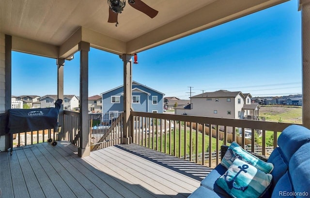 deck featuring ceiling fan and a yard