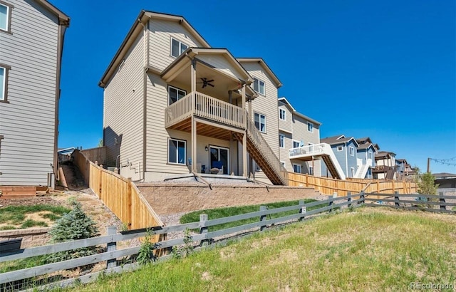 rear view of property featuring a balcony and ceiling fan