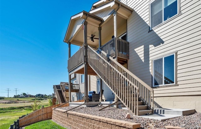 back of property featuring ceiling fan and a wooden deck