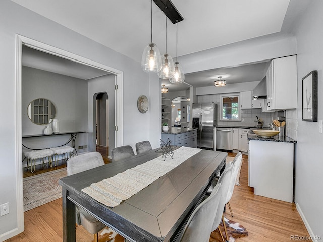 3282 Depew St, Wheat Ridge, CO 80212 - dining space featuring arched walkways and light wood finished floors