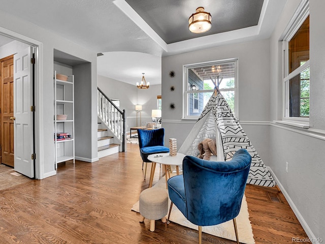 3282 Depew St, Wheat Ridge, CO 80212 - living area featuring stairs, a chandelier, and wood finished floors