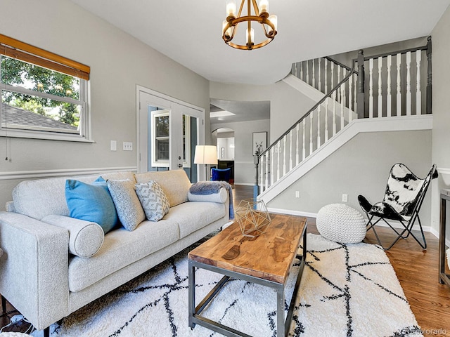 3282 Depew St, Wheat Ridge, CO 80212 - living room with arched walkways, stairway, wood finished floors, and a chandelier