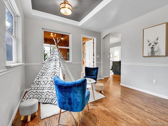 3282 Depew St, Wheat Ridge, CO 80212 - living area with arched walkways, wood finished floors, and a raised ceiling