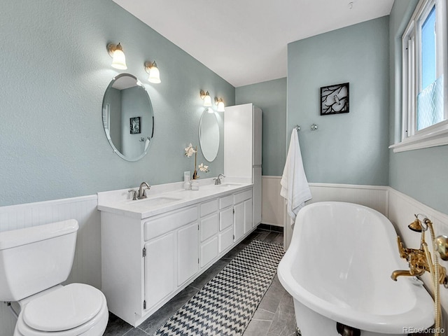 3282 Depew St, Wheat Ridge, CO 80212 - full bath featuring a soaking tub, wainscoting, and double vanity