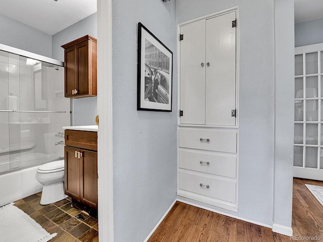 3282 Depew St, Wheat Ridge, CO 80212 - bathroom with combined bath / shower with glass door, wood finished floors, and vanity