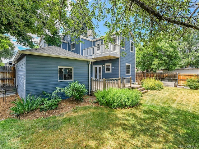 3282 Depew St, Wheat Ridge, CO 80212 - back of property featuring a balcony, a fenced backyard, and french doors