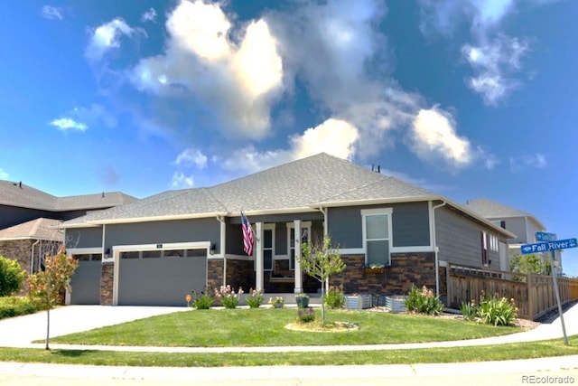 599 Fall River Ct, Brighton, CO 80601 - view of front of home with an attached garage, stone siding, and concrete driveway