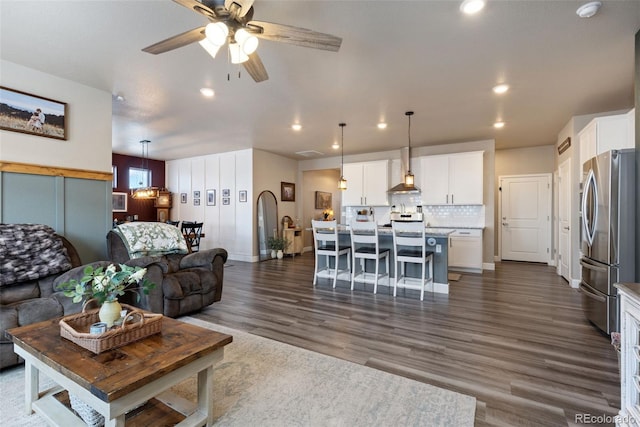 599 Fall River Ct, Brighton, CO 80601 - living area with recessed lighting, dark wood finished floors, and a ceiling fan