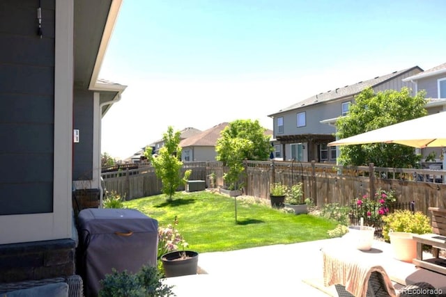 599 Fall River Ct, Brighton, CO 80601 - fenced backyard featuring a patio, a residential view, and area for grilling