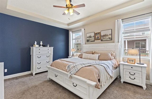 599 Fall River Ct, Brighton, CO 80601 - bedroom with a tray ceiling, carpet floors, and a ceiling fan